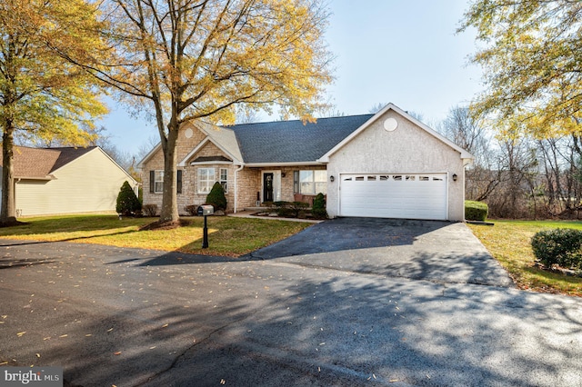 view of front of home with stucco siding, driveway, a front yard, and a garage