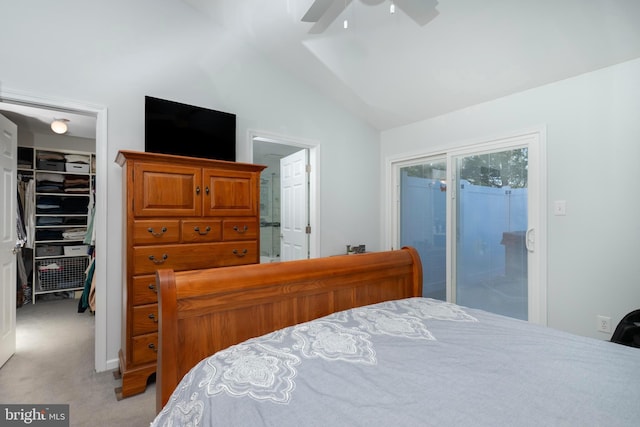 bedroom with a walk in closet, light carpet, a closet, lofted ceiling, and access to exterior