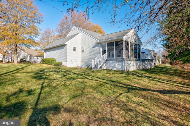 view of home's exterior featuring a yard and a sunroom