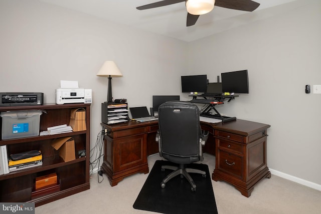 home office with baseboards, light carpet, and ceiling fan