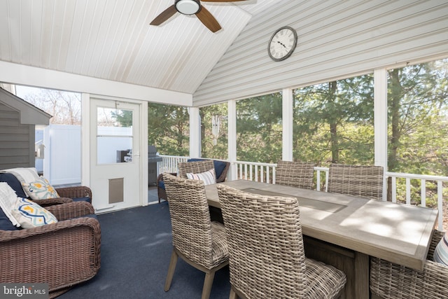 sunroom with a wealth of natural light, ceiling fan, and vaulted ceiling