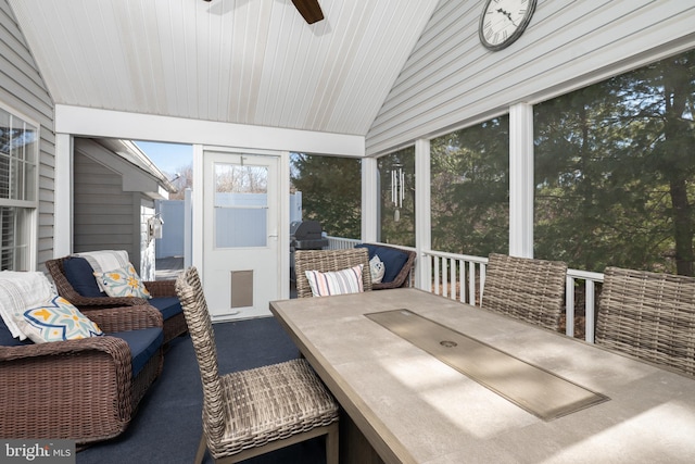 sunroom featuring a ceiling fan and vaulted ceiling