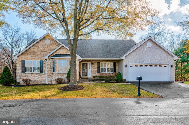 view of front of home with an attached garage, driveway, a front lawn, and roof with shingles