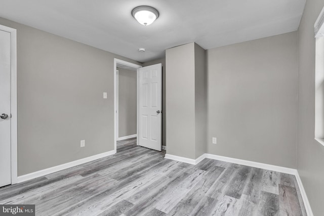 unfurnished bedroom featuring baseboards and wood finished floors