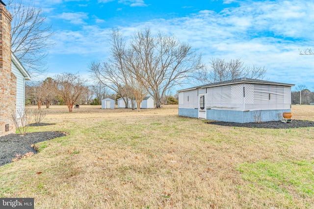 view of yard with a storage shed and an outdoor structure