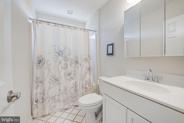 bathroom featuring a shower with shower curtain, toilet, and vanity