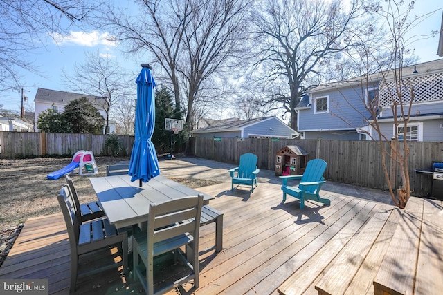 wooden deck featuring outdoor dining space and a fenced backyard