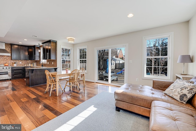 living area with recessed lighting, baseboards, and wood finished floors