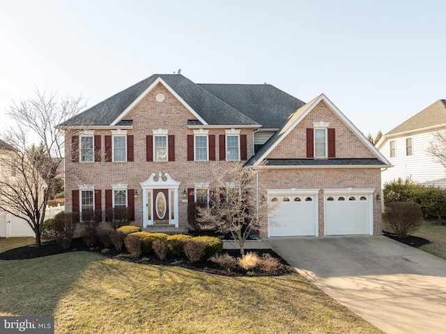 view of front of house with brick siding, an attached garage, driveway, and a front yard