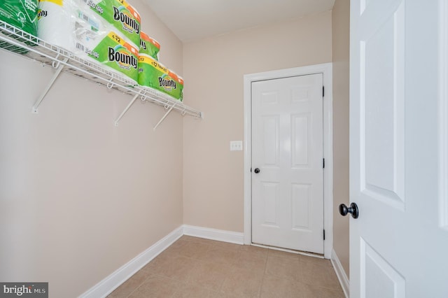 walk in closet with light tile patterned floors