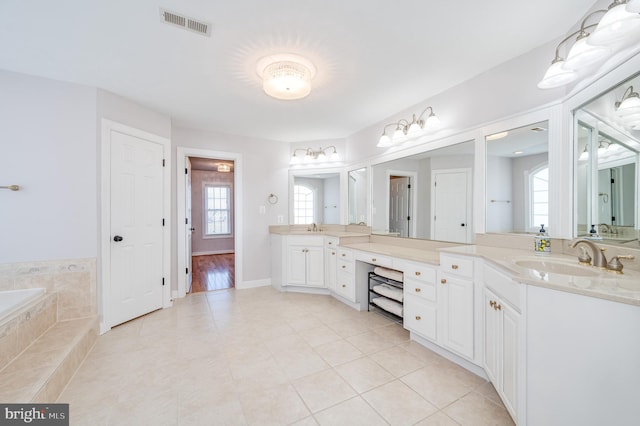 full bathroom featuring vanity, baseboards, visible vents, a garden tub, and tile patterned floors