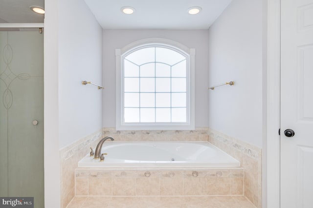 bathroom featuring a garden tub, recessed lighting, and a shower stall