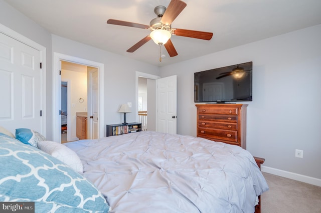 bedroom featuring connected bathroom, a ceiling fan, baseboards, and carpet floors