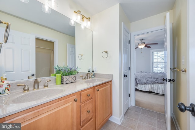 full bath featuring tile patterned flooring, connected bathroom, double vanity, and a sink