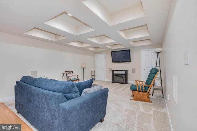 living area featuring baseboards, light carpet, and a glass covered fireplace