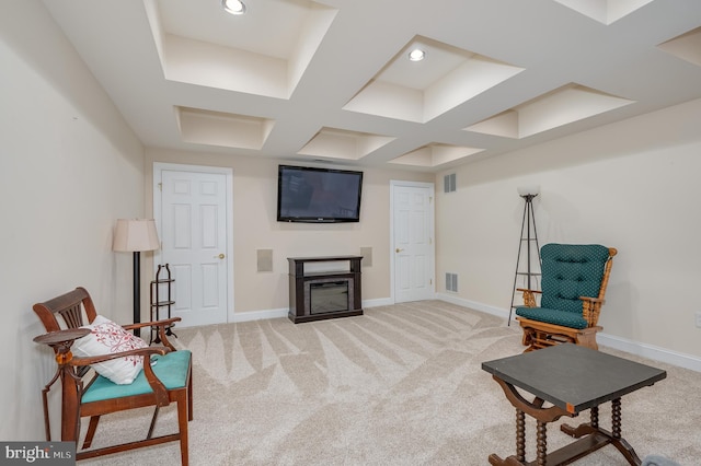 living area featuring baseboards, light carpet, and a glass covered fireplace