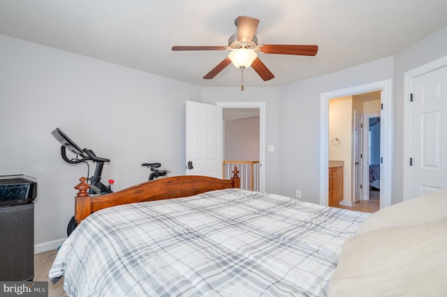 bedroom with a ceiling fan, light colored carpet, and baseboards