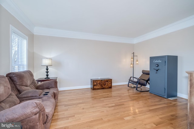 living room with baseboards, light wood-style floors, and crown molding