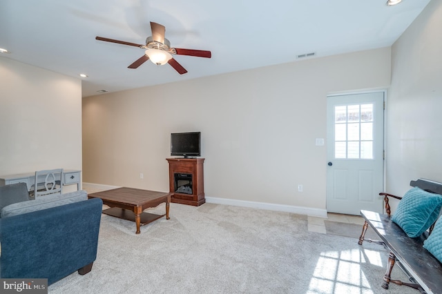 living room with baseboards, visible vents, recessed lighting, ceiling fan, and light colored carpet