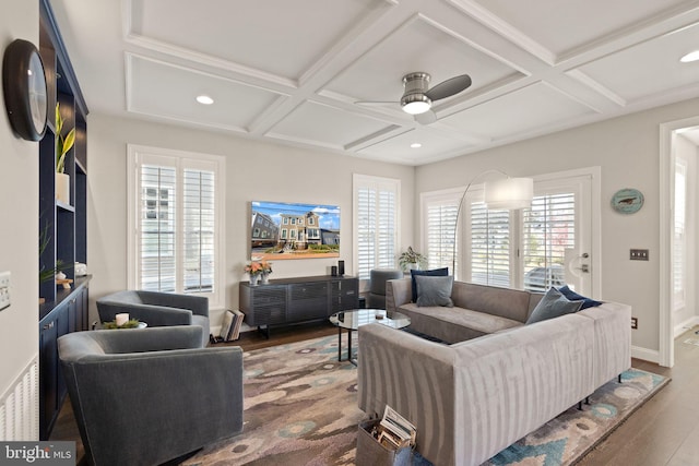 living room featuring plenty of natural light, wood finished floors, and coffered ceiling