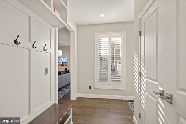 mudroom with visible vents, dark wood-type flooring, and baseboards