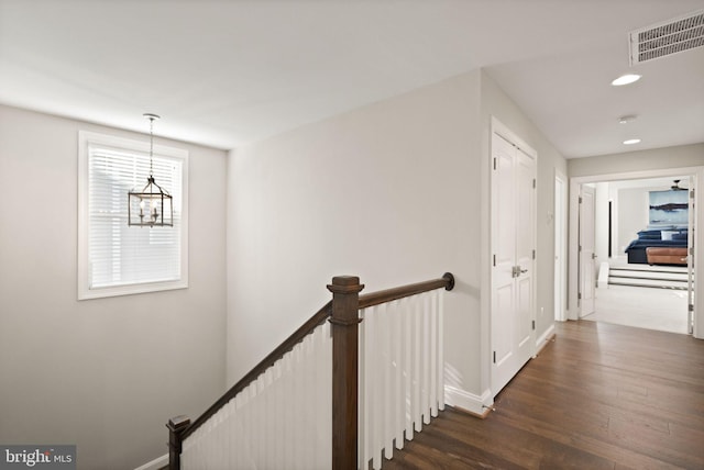 stairway with visible vents, recessed lighting, baseboards, and wood finished floors