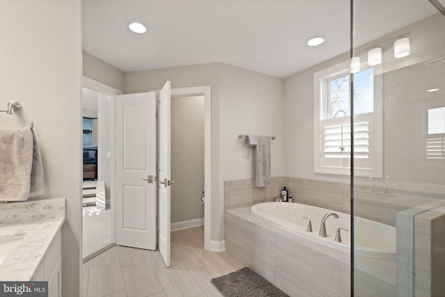 full bath with recessed lighting, a garden tub, and vanity