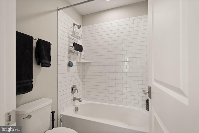 bathroom featuring shower / bathing tub combination and toilet