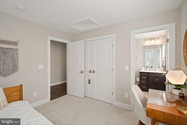 bedroom with visible vents, a closet, baseboards, light colored carpet, and attic access