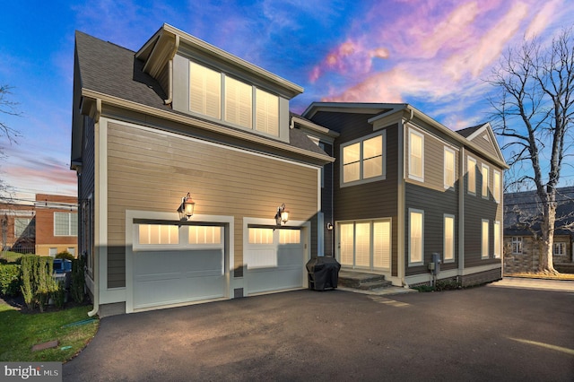 view of front facade featuring aphalt driveway and a garage