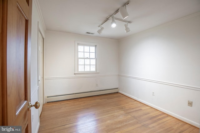 unfurnished room featuring visible vents, baseboards, ornamental molding, light wood-style flooring, and a baseboard radiator