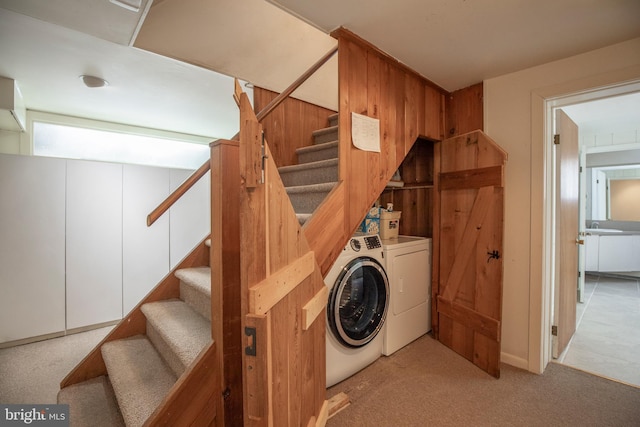 laundry room with laundry area, light colored carpet, and independent washer and dryer