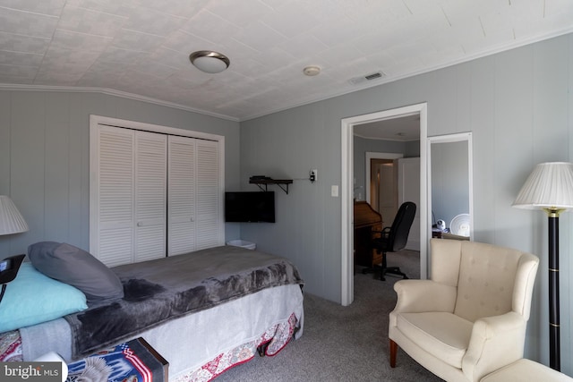 carpeted bedroom with a closet, visible vents, and ornamental molding