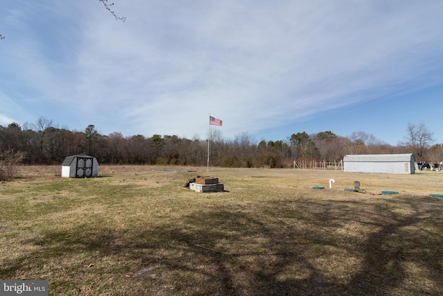 view of yard featuring an outbuilding and a shed