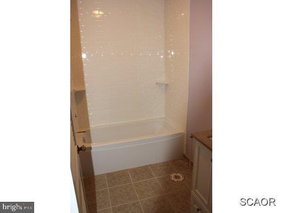 bathroom with tile patterned floors, tub / shower combination, and vanity