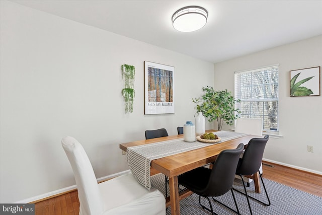 dining room featuring baseboards and wood finished floors