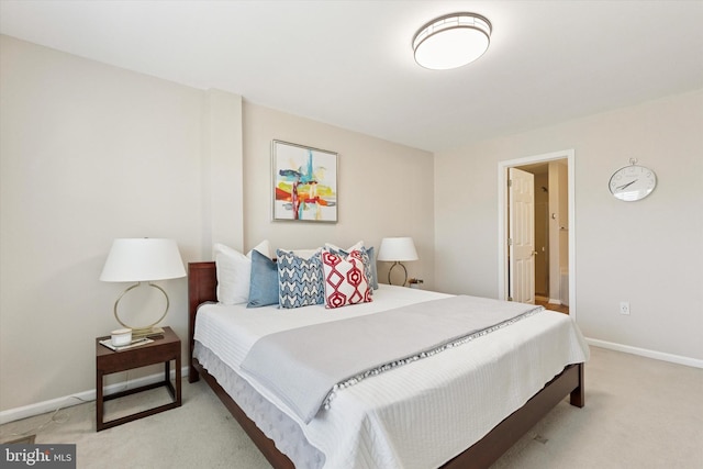 bedroom featuring light carpet and baseboards