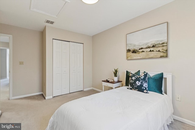 bedroom featuring visible vents, a closet, carpet flooring, baseboards, and attic access