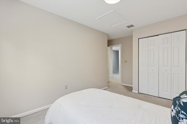 bedroom featuring visible vents, light carpet, a closet, baseboards, and attic access