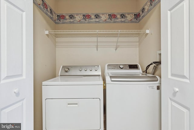 washroom with laundry area and washer and dryer