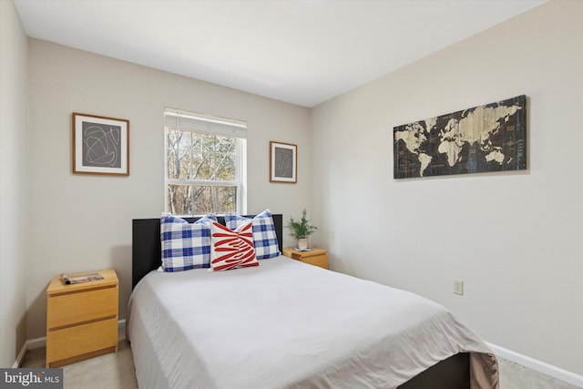 bedroom featuring baseboards and carpet