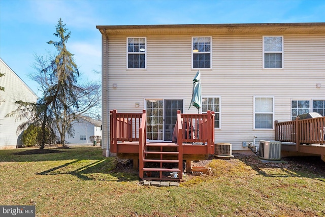 back of house with central air condition unit, a lawn, and a wooden deck