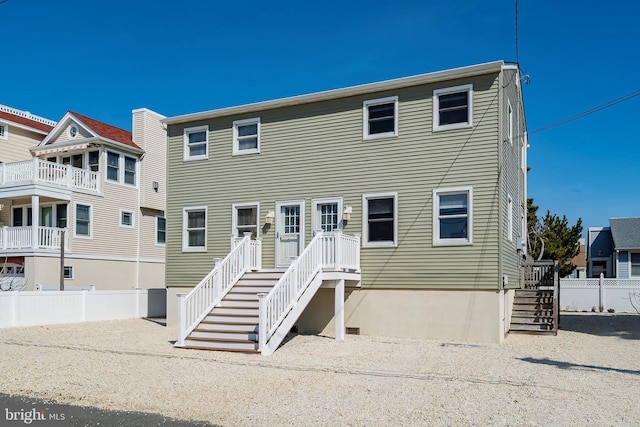 view of front of home with stairs and fence