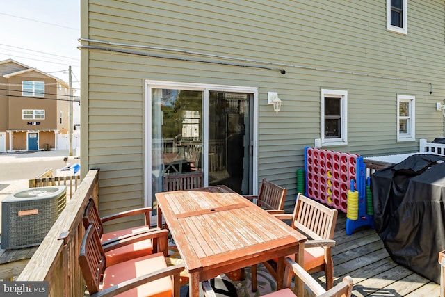 deck with central air condition unit and outdoor dining area