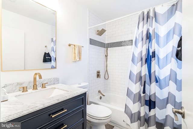 full bathroom with vanity, shower / tub combo, and toilet