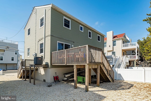 rear view of house featuring a deck, stairway, fence, and central AC