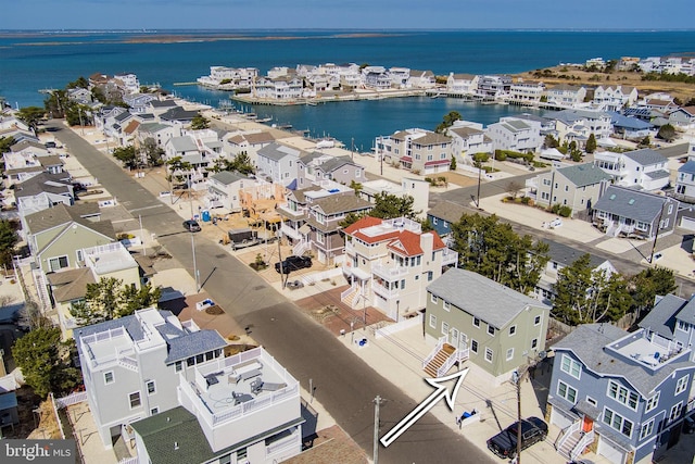 birds eye view of property with a residential view and a water view