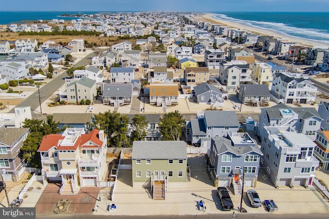 birds eye view of property with a view of the beach, a water view, and a residential view