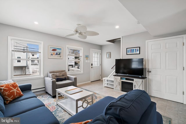 living area with recessed lighting, a baseboard radiator, baseboards, and ceiling fan