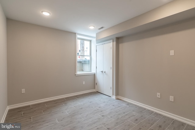 interior space featuring light wood finished floors, visible vents, and baseboards